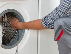 Dryer repair technician diagnosing and servicing a clothes dryer in Sacramento, CA