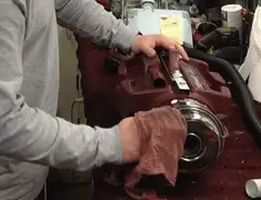 Vacuum repair technician cleaning and servicing a vacuum motor in Sacramento, CA