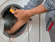 Washing machine repair technician testing a front-load washer with diagnostic tools in Sacramento, CA